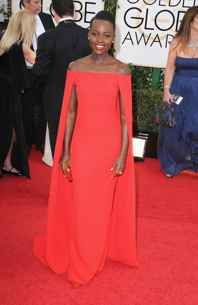 Lupita Nyong'o in Ralph Lauren is modern & elegant with her strapless cape gown and minimal jewels.